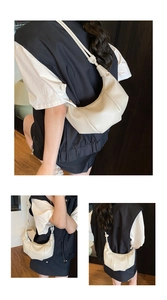Detail of off-white hobo bag showing soft leather texture and stylish knotted shoulder strap