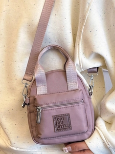 Fashionable dusty pink nylon mini crossbody bag with top handles and front zipper pocket