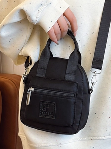 Fashionable black nylon mini crossbody bag with top handles and adjustable shoulder strap