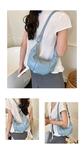 Detail of light blue pleated croissant bag with adjustable strap for shoulder wear
