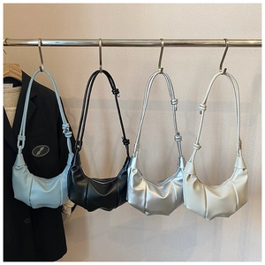 Detail showing pleated dumpling bags in blue black silver and off-white colors