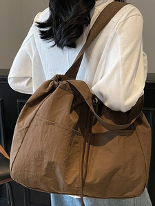 Large waterproof nylon drawstring tote bag in brown for travel and casual shoulder use