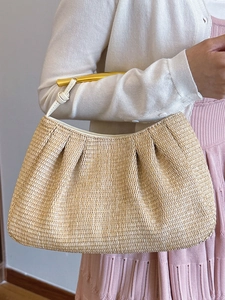 Exquisite woven straw handbag with golden metal handles for summer beach vacation style