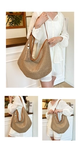 Close-up detail of large straw tote bag with brown leather handles and tassel accent
