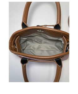 Detailed interior of the shell bag showing herringbone lining and magnetic snap closure