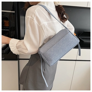 Fashionable light blue pillow bag with fabric texture shown in a casual lifestyle setting