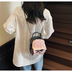 Detailed view of the pink quilted fabric and black bow on the sweet mini bucket backpack