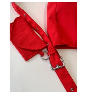 Detail of red canvas tote with adjustable shoulder strap and silver metal hardware