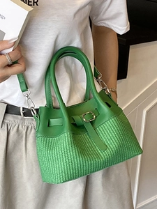 Green bucket bag featuring leather stitching and woven texture with silver hardware