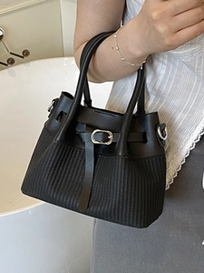 Fashionable black bucket bag with vertical stripe texture and elegant silver metal hardware