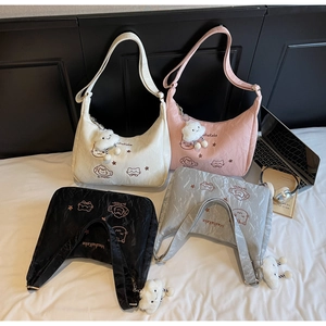 Detail of four colorful shoulder bags with cute cat embroidery and cloud plush charms