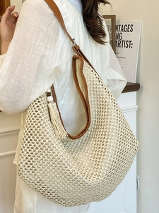 French style woven straw shoulder bag with leather trim and fringe detail for beach
