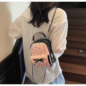 Detail of sweet bow bubble gauze mini backpack with heart pendant and chain strap