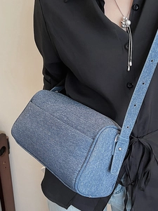 Chic blue denim cylindrical crossbody bag for women with adjustable shoulder strap detail