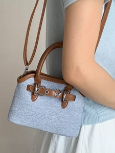 Minimalist light blue denim shell bag with brown leather handles for women's crossbody wear