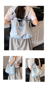 Detailed view of light blue jacquard tote bag with drawstring closure and beads