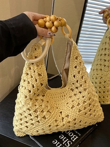 Large capacity woven straw tote bag for women featuring yellow hollow crochet and wooden bead handle