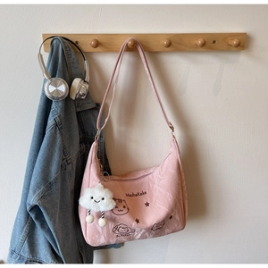 Pink nylon hobo bag detail with cartoon cat embroidery and white cloud plush charm