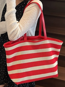 Red and white striped woven tote bag with leather straps for a stylish summer look