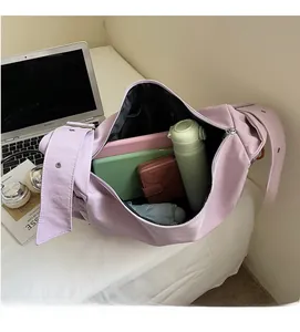 Detailed interior of a large purple canvas tote showing laptop and umbrella storage
