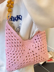 Pink hand-crochet woven tote bag with yellow wooden bead handles for summer beach vacations