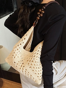 Bohemian off-white hand-crocheted tote bag with large dark brown wooden bead shoulder strap