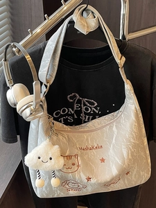 Silver crescent hobo bag with cute cat embroidery and cloud charm on a hanger