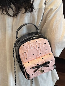Mini seersucker backpack with pink bow pattern and metallic chain strap for women