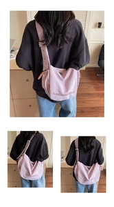 Detail of light purple canvas crossbody bag featuring adjustable strap and embroidery