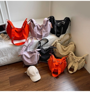 Detail of colorful canvas tote bags with adjustable straps and side zipper pockets