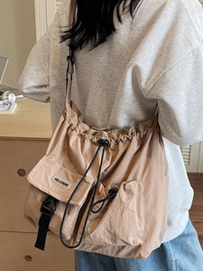 Khaki high-capacity drawstring canvas crossbody bag with dual utility pockets