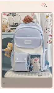 Detail of light blue school backpack with multi-pocket design and transparent card holder