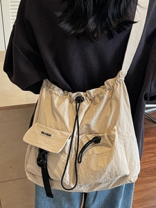Large beige canvas tote bag with ruched texture and multi-pocket design for daily commute