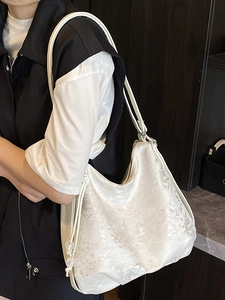 Elegant white jacquard hobo tote bag with floral patterns and beaded drawstring detail
