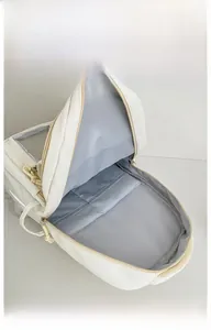 Interior view of white backpack showing spacious main compartment and internal pockets