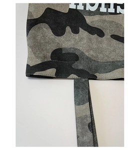 Macro view of waterproof camo tote fabric with precision industrial stitching details
