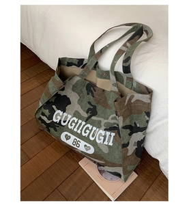 Close-up of large camo canvas tote bag with GUGIIGUGII logo and number 86 print