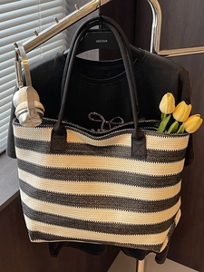 Woven striped straw tote bag in black and white for summer beach vacation and daily use