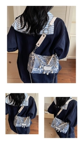 Detail of blue striped tote bag with pearl fringe and metallic chain accents