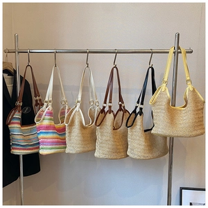 Detailed display of assorted summer woven straw beach bags in multiple color patterns