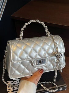 Silver quilted leather chain crossbody bag with metallic finish and adjustable ball charm