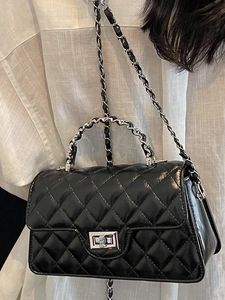 Black quilted crossbody bag with silver chain strap and metal turn-lock closure