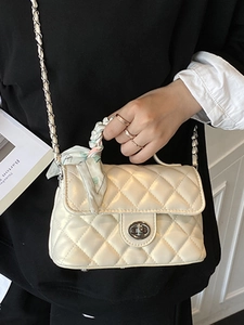 Quilted cream crossbody bag with floral scarf handle and silver twist lock closure