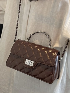 Deep brown quilted crossbody bag with silver chain strap and polished metal twist lock