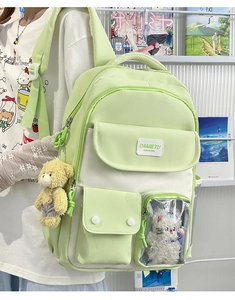Detail view of the green and beige kawaii ita bag with a clear window and plush toy insert