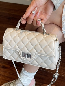 Quilted cream leather crossbody bag with chain handle and silver metal turn-lock