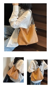 Detail of woven straw tote bag featuring a zebra-patterned fabric shoulder strap detail