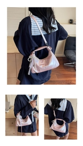 Detail view of pink oil wax leather crossbody bag with lace pearl bow and fashion embossing