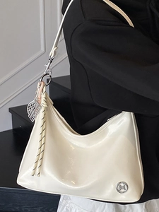 Chic white patent leather tote bag with braided charm for 2025 summer commute style