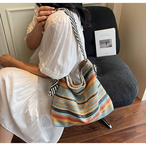 Macro shot of colorful striped woven tote bag with a nautical knot shoulder strap